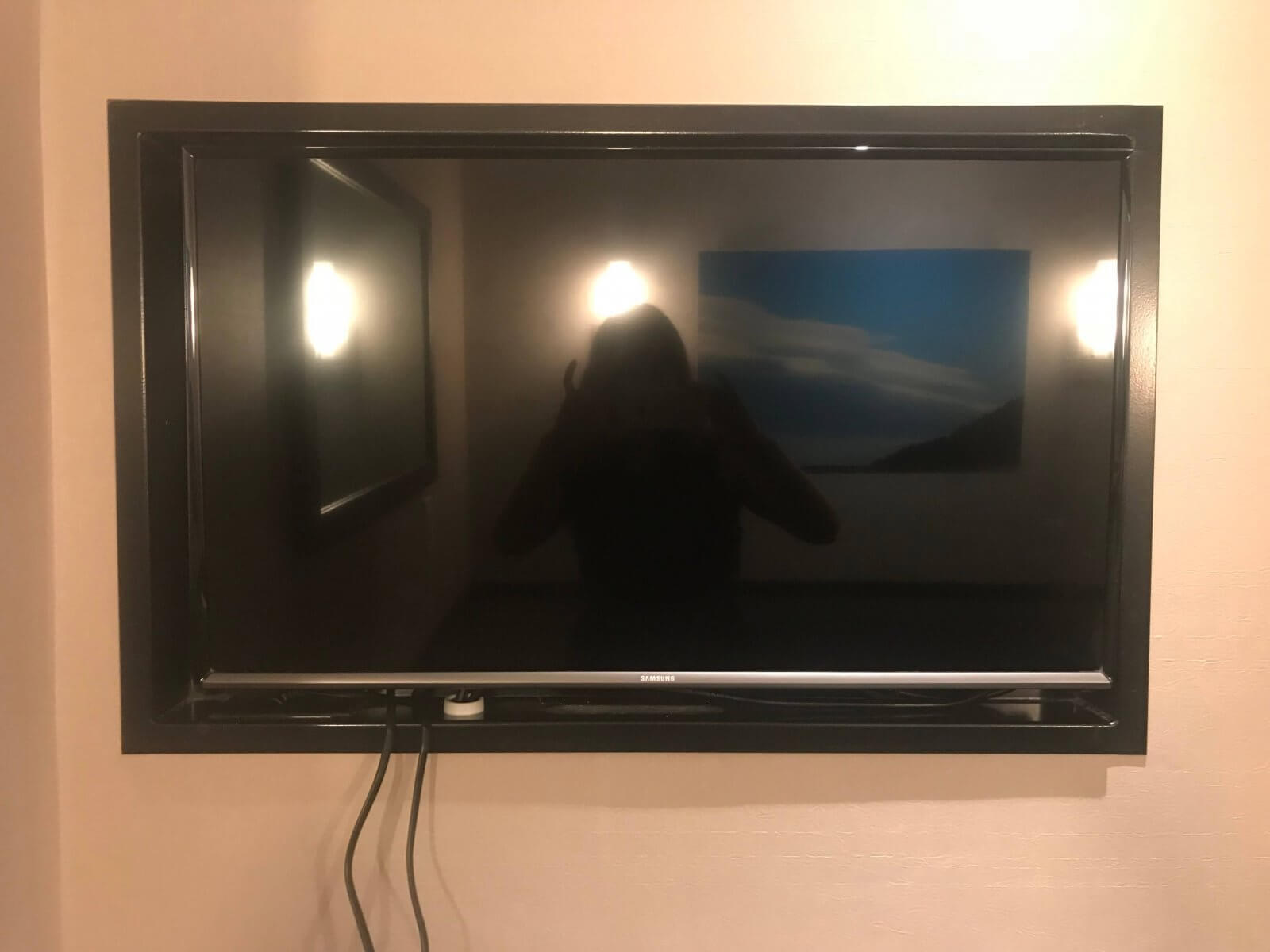 A Large Flat Screen TV is On the Wall