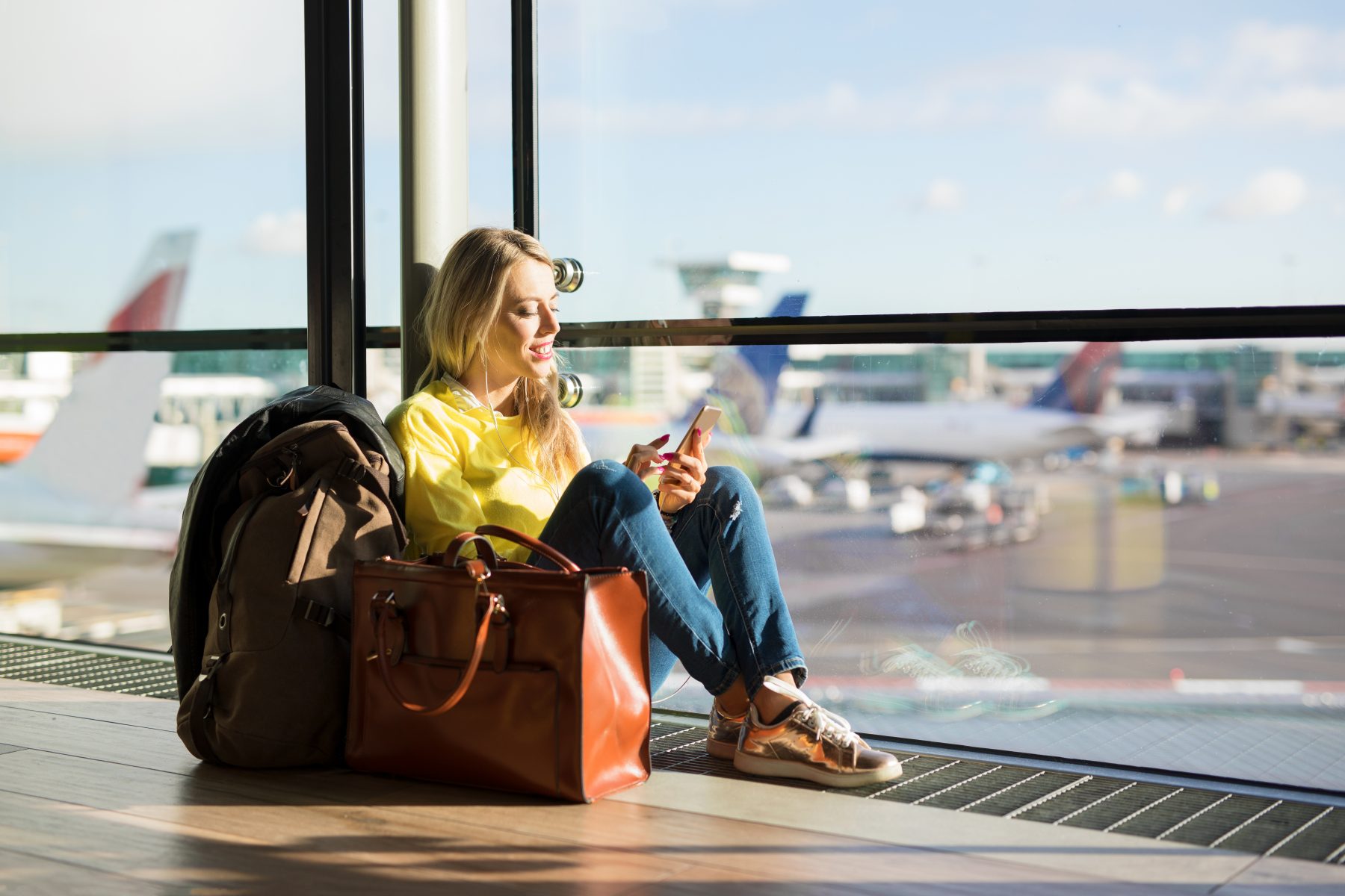 Woman sitting in airport and waiting for her flight
