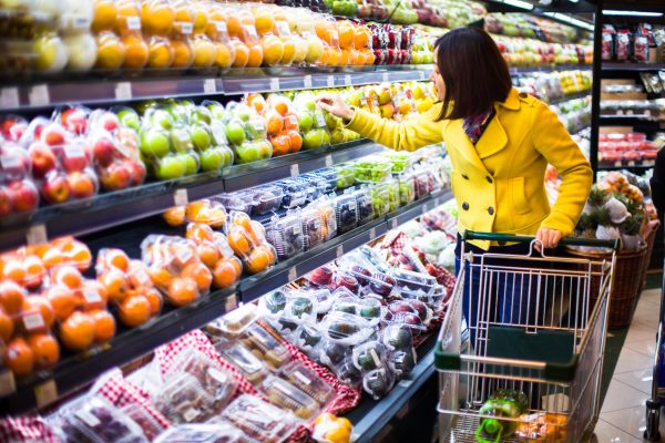 Woman buying vegtables at grocery store