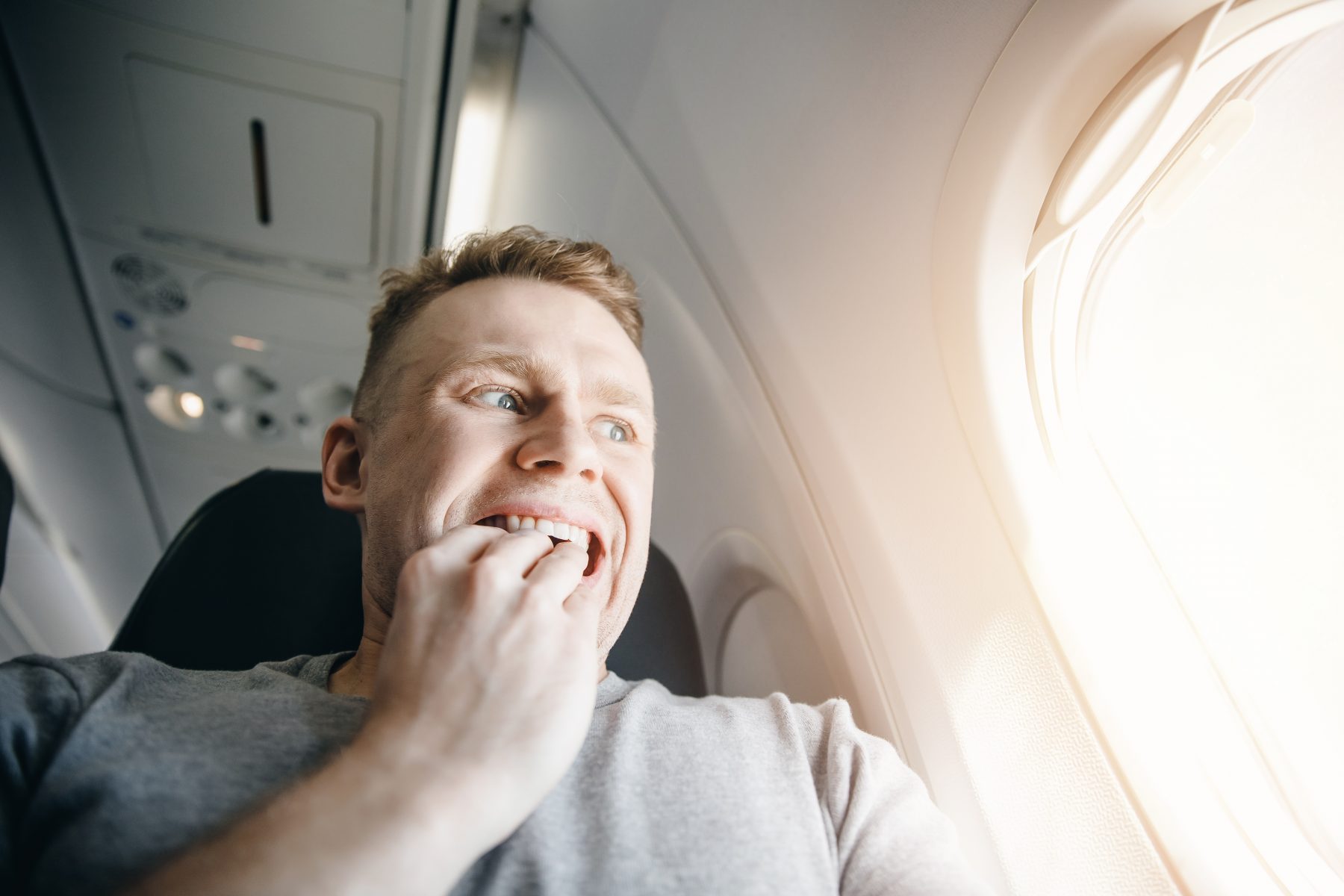 Guy scared looking out plane window