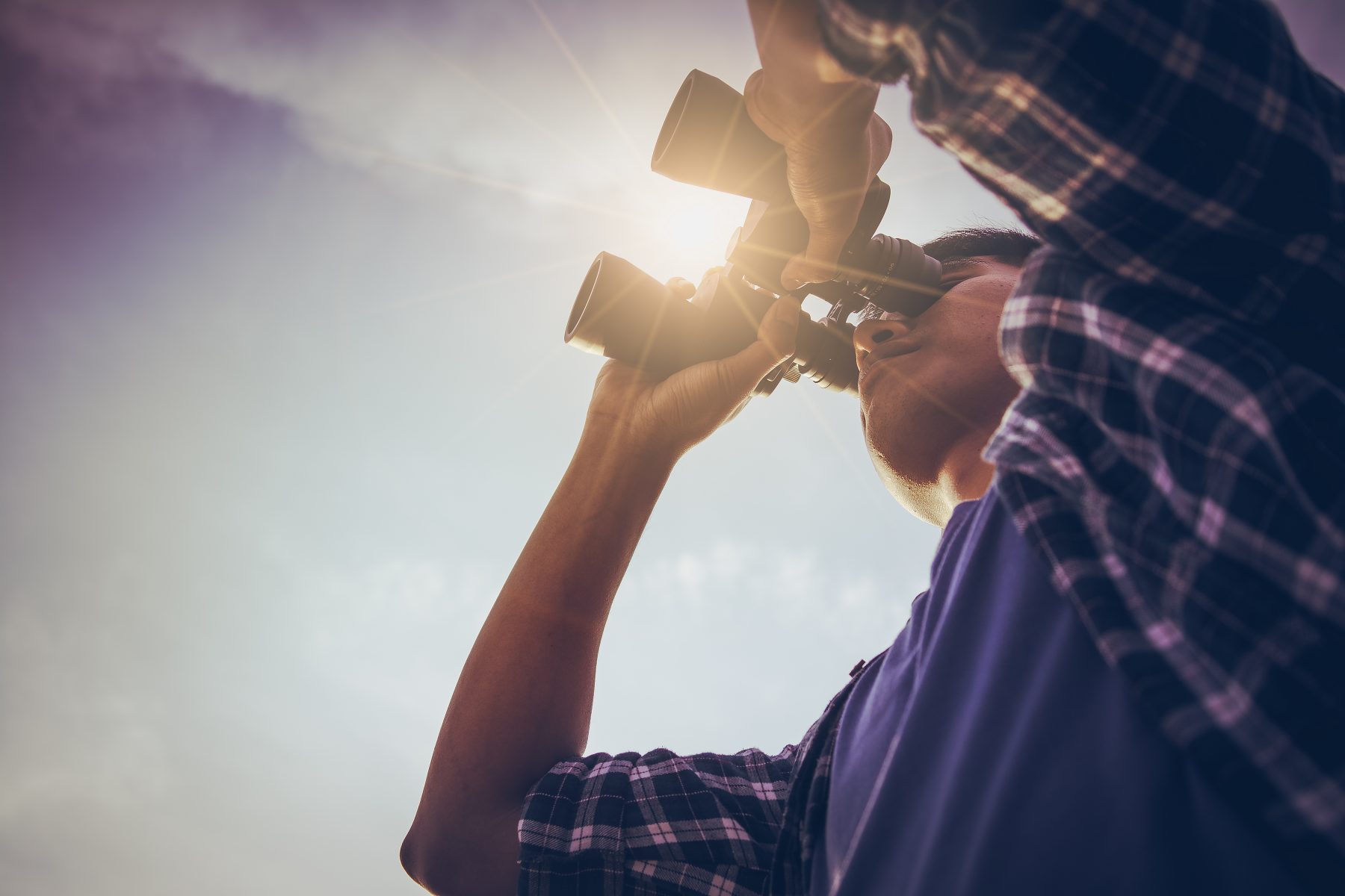 Man looking through binoculars