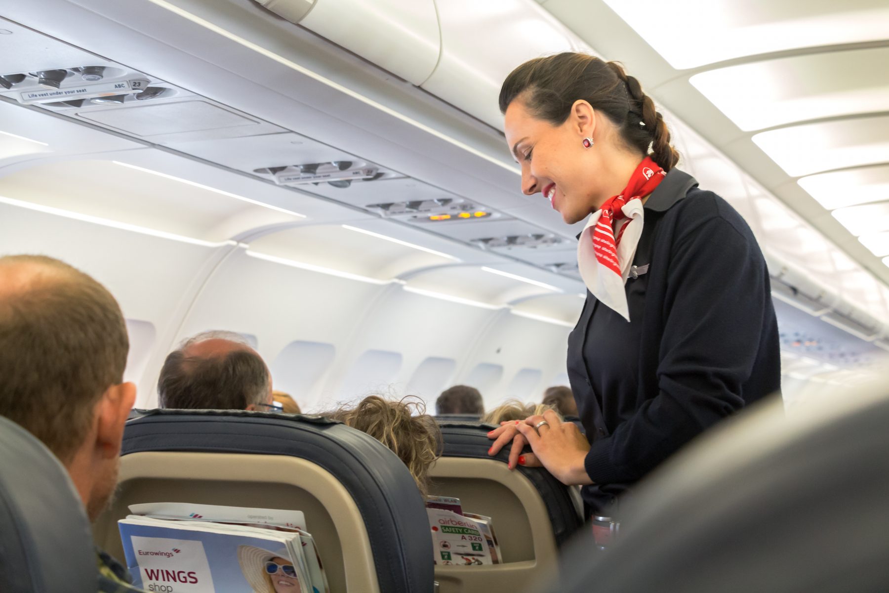 Friendly flight attendant re-assuring nervous guest