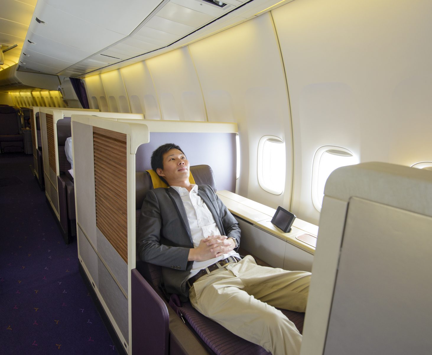 Adult relaxing in first class airline seat