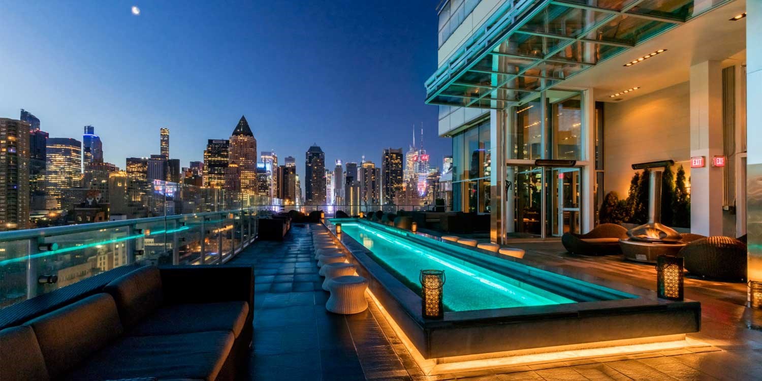 Guests Love Hanging Out at the Kimpton Ink48's Beautiful Rooftop Terrace Overlooking the City at Night